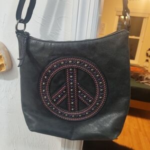 The Sak Black Crossbody Bag with Embroidered Peace Sign